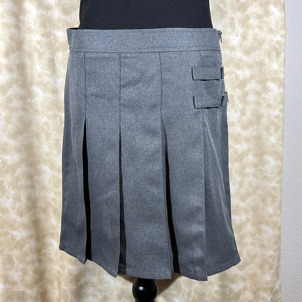 Pleated midi skort . With side zipper and faux buckle detail.